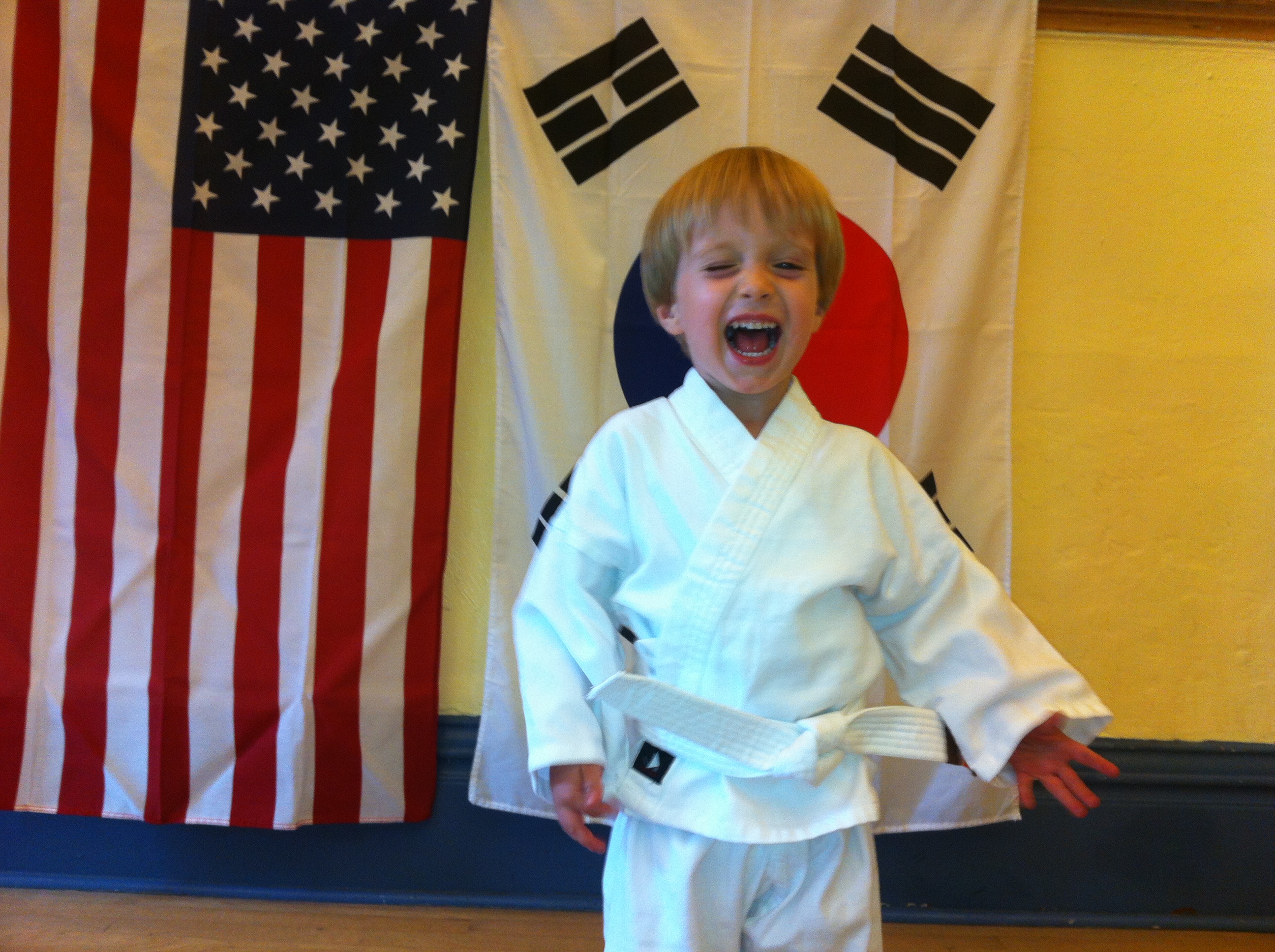 Joyful young student in dobok — the family-friendly side of Holon Wellness